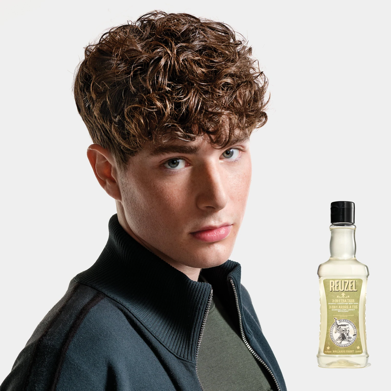 Reuzelinc 3-in-1 Tea Tree Shampoo bottle with label, featuring natural tea tree ingredients and a sleek design., view 6