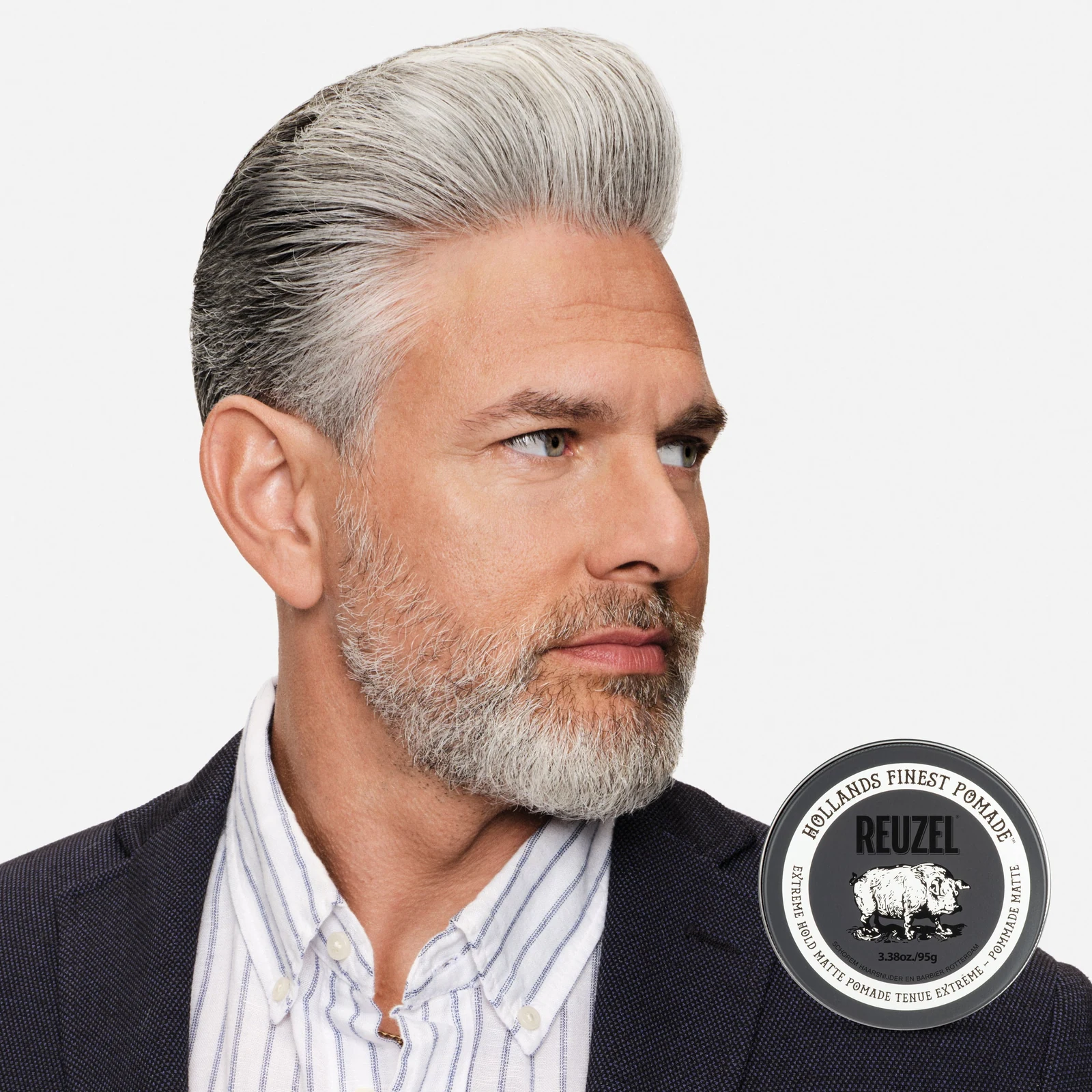 Reuzel Extreme Hold Matte Pomade jar with black label and silver lid, showcasing the product for strong, matte hairstyle hold.