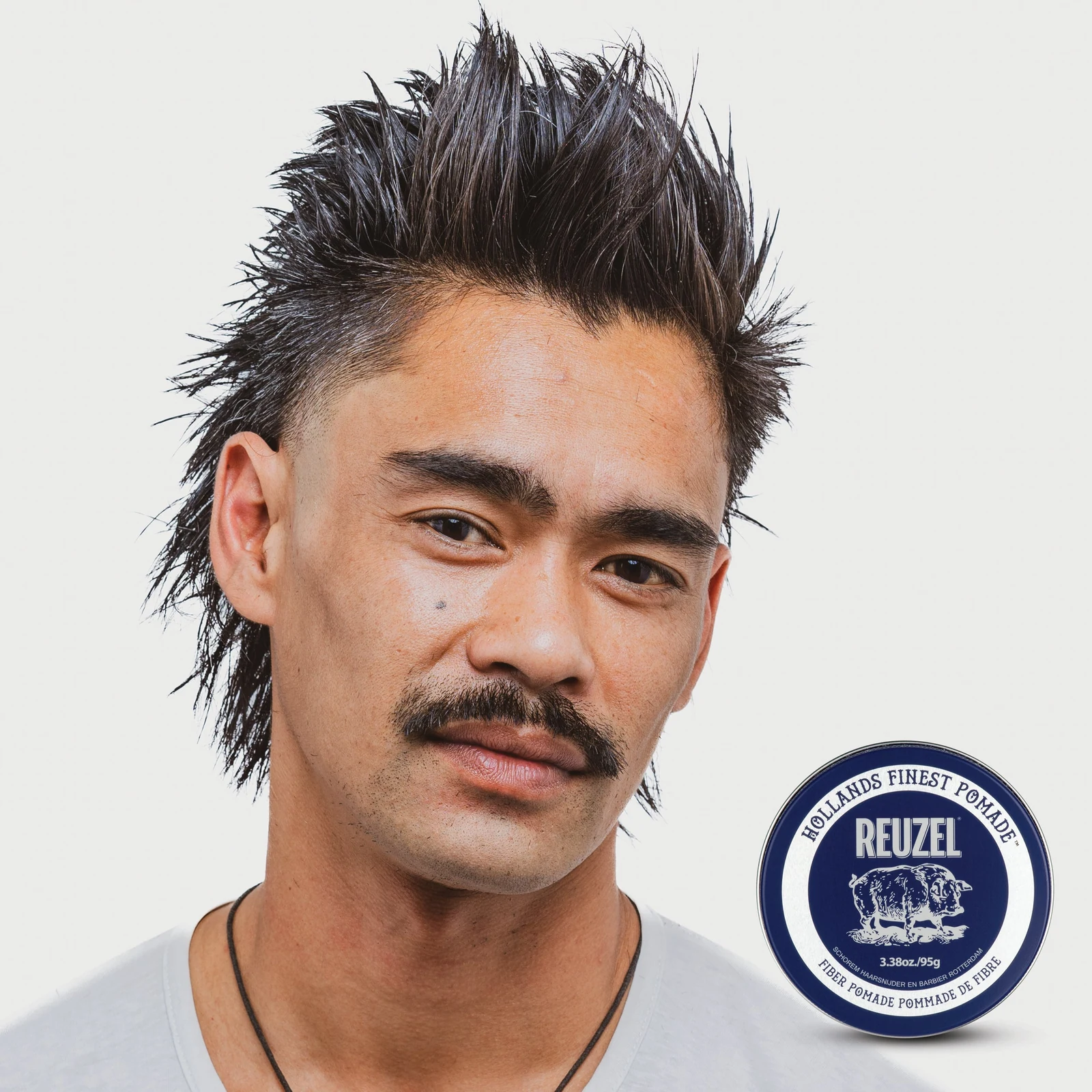 Reuzelinc Fiber Pomade jar with black lid and label, showing the pomade's thick, fiber-rich texture for styling hair., view 8