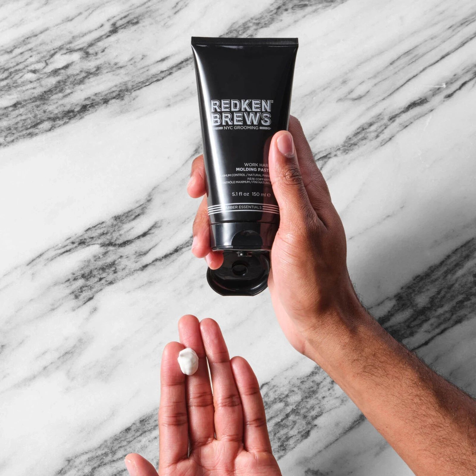 Redken Brews Molding Paste texture shown in hand for scale