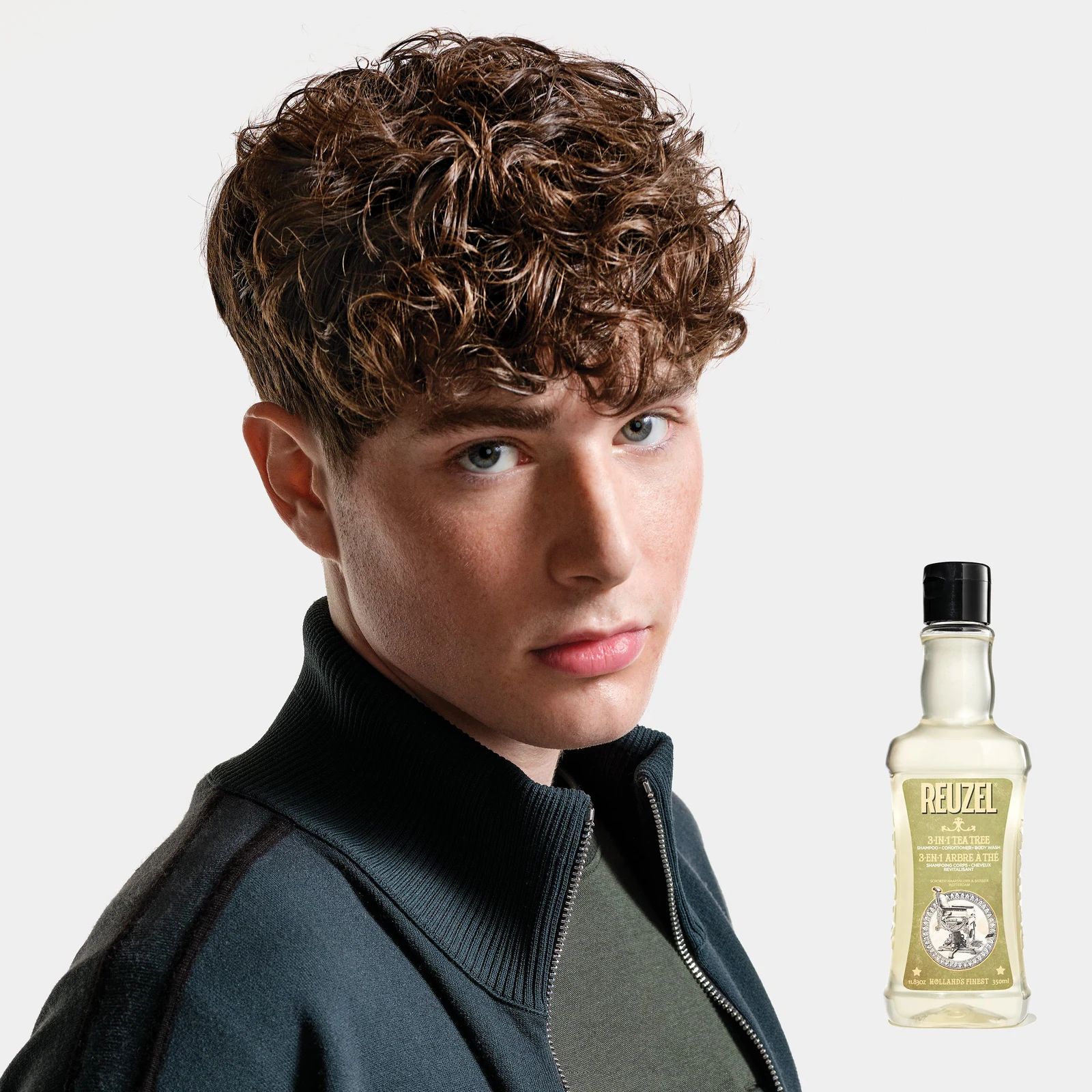 Reuzelinc 3-in-1 Tea Tree Shampoo bottle with label, featuring natural tea tree ingredients and a sleek design., view 6