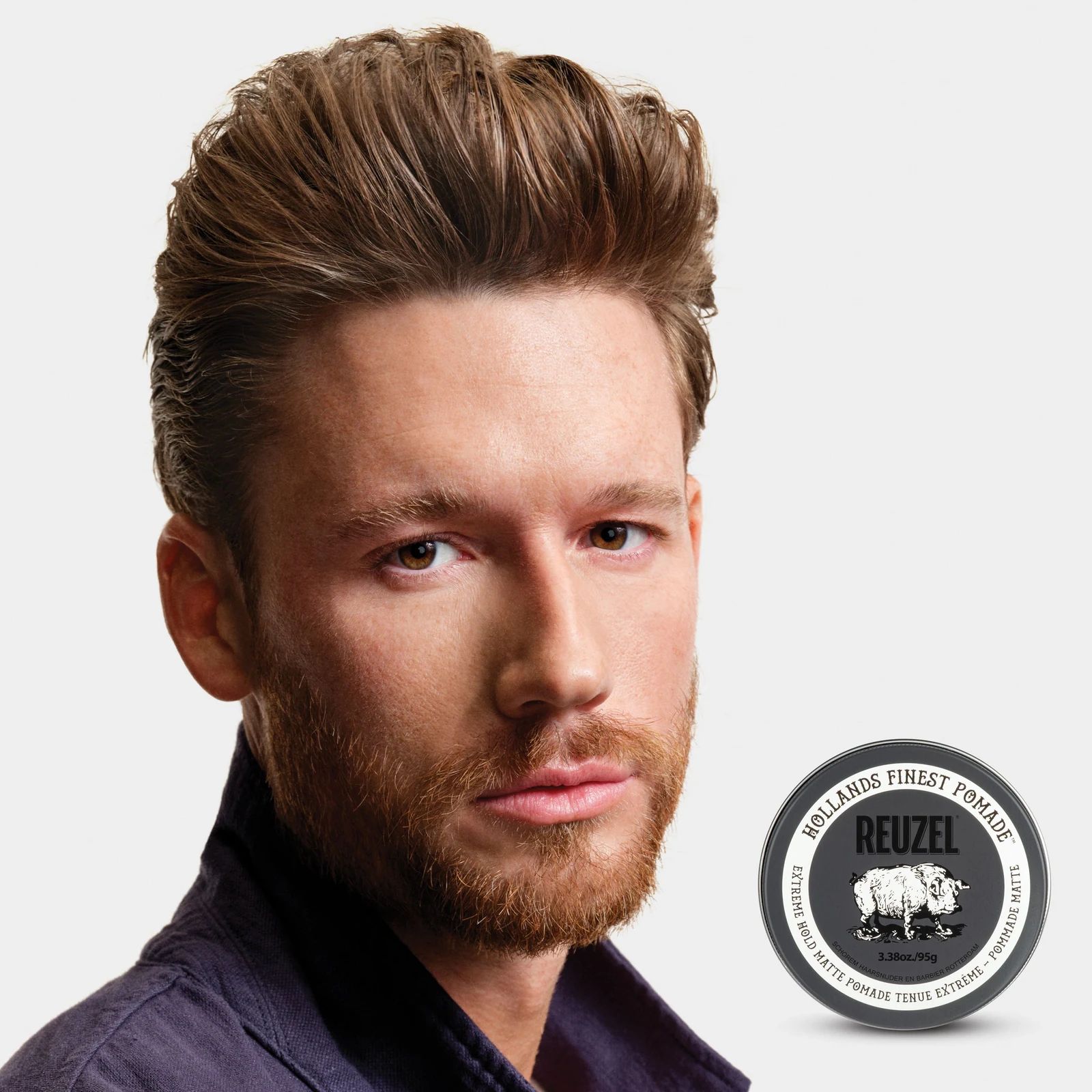 Reuzel Extreme Hold Matte Pomade - 340g: Male model with short brown hair and beard next to REUZEL extreme matte pomade, view 7