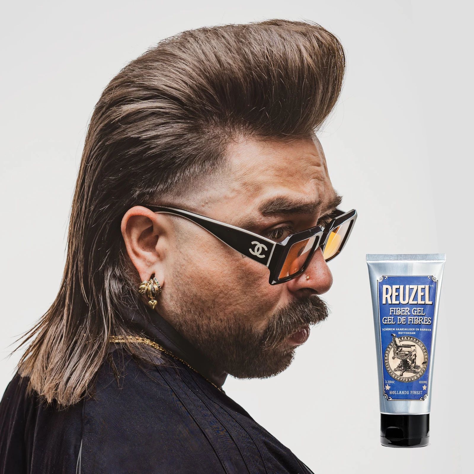 Reuzelinc fiber hair gel in a jar, styled with a thick, textured look showing its strong hold for hair styling., view 7