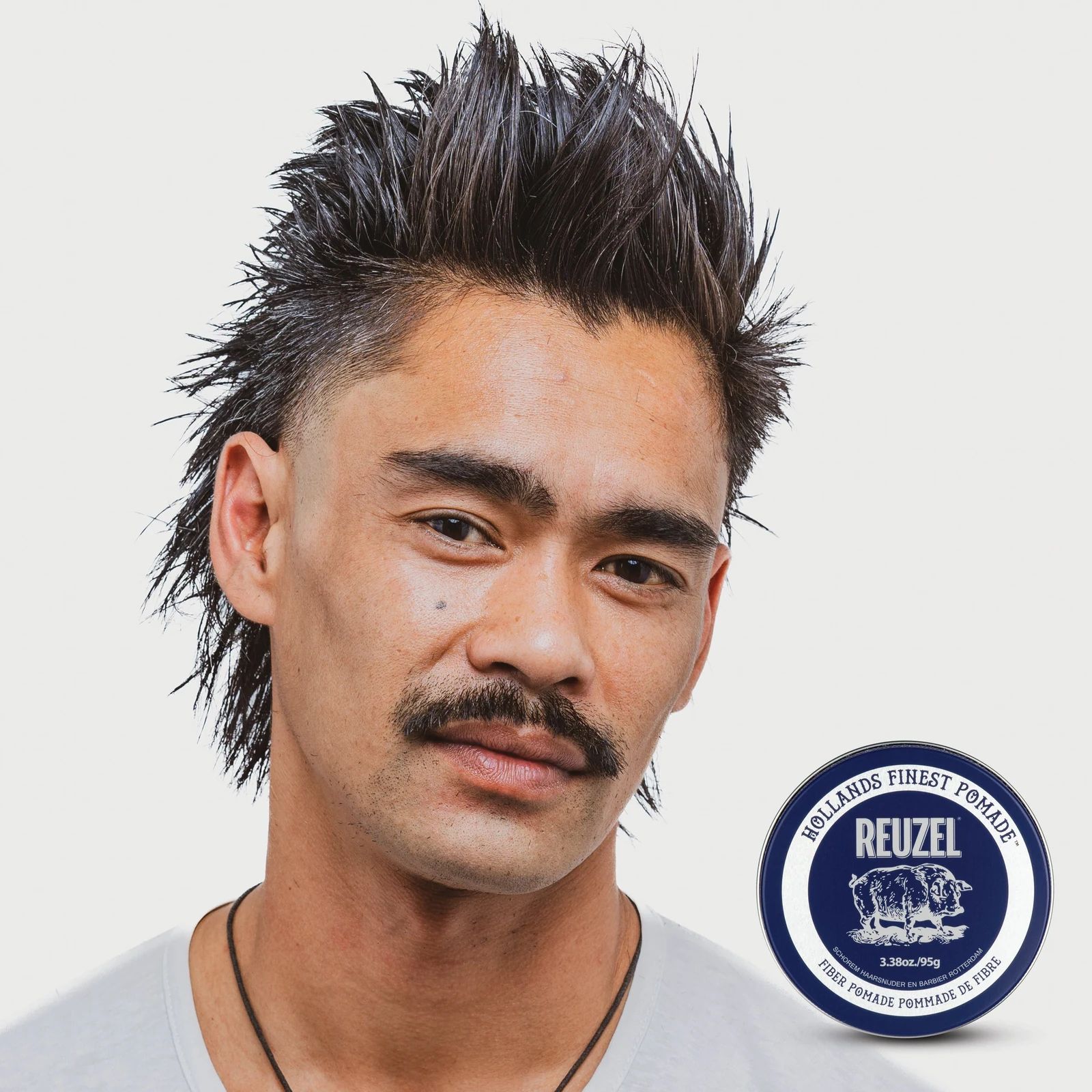 Reuzelinc Fiber Pomade jar with black lid and label, showing the pomade's thick, fiber-rich texture for styling hair., view 8