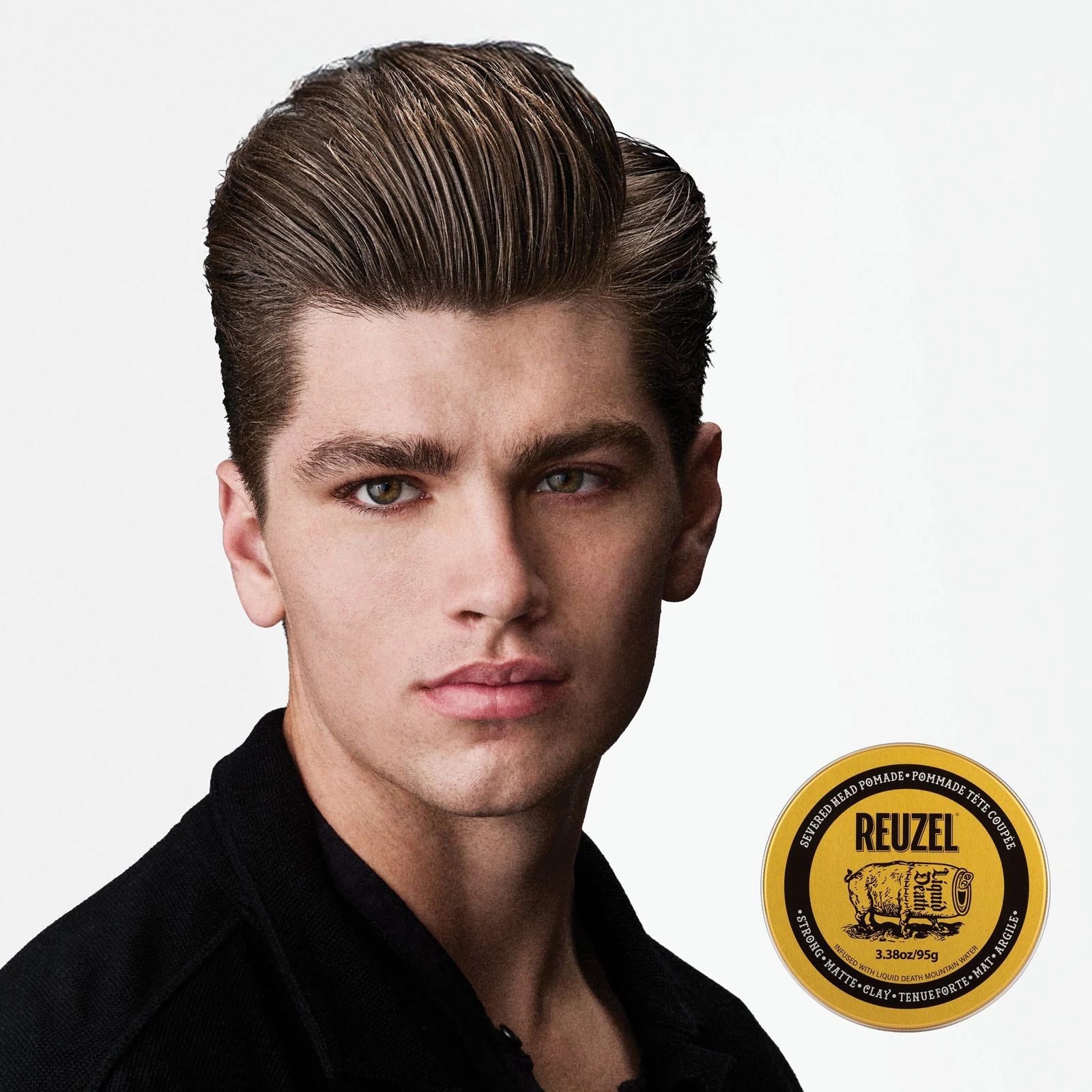 Reuzel - Strong Matte Clay - Liquid Death: Man with styled hair next to a puck of REUZEL x Liquid Death Severed Head Strong Matte Clay Pomad on a white bac