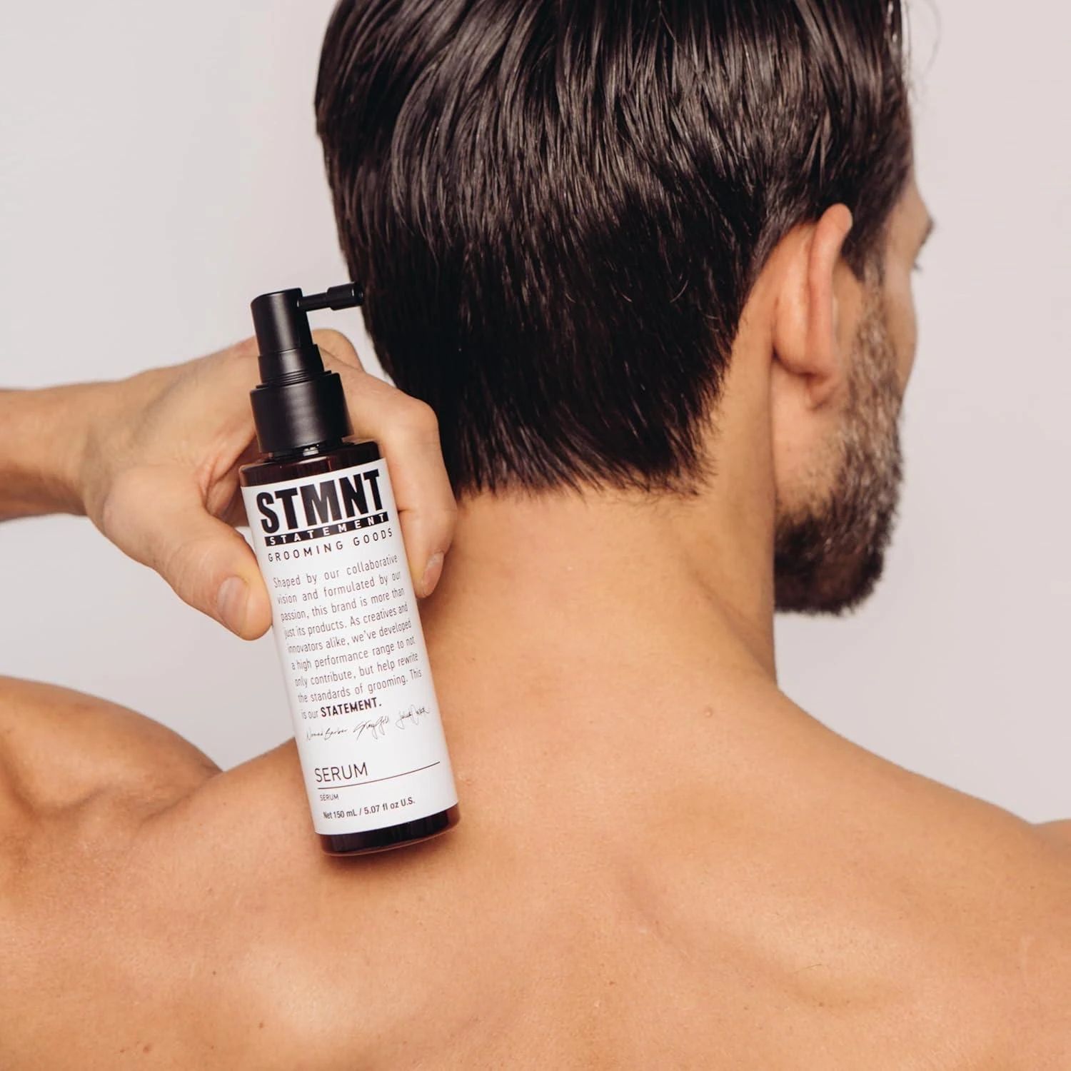 STMNT Serum 150ml shown against a finished haircut for scale